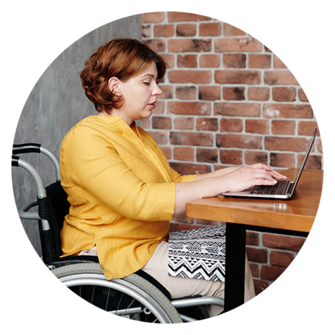 woman in wheelchair working at desk