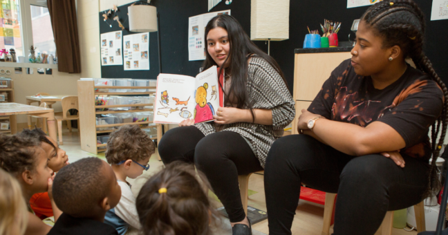 a teacher reading to a group of elementary school children