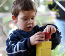 Photo of toddler playing with blocks